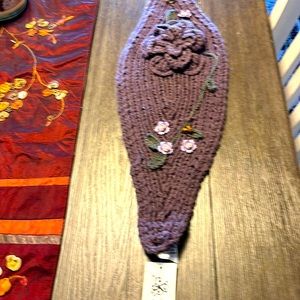 2 hand knit ear warmers. With crochet flowers on sides, button closure